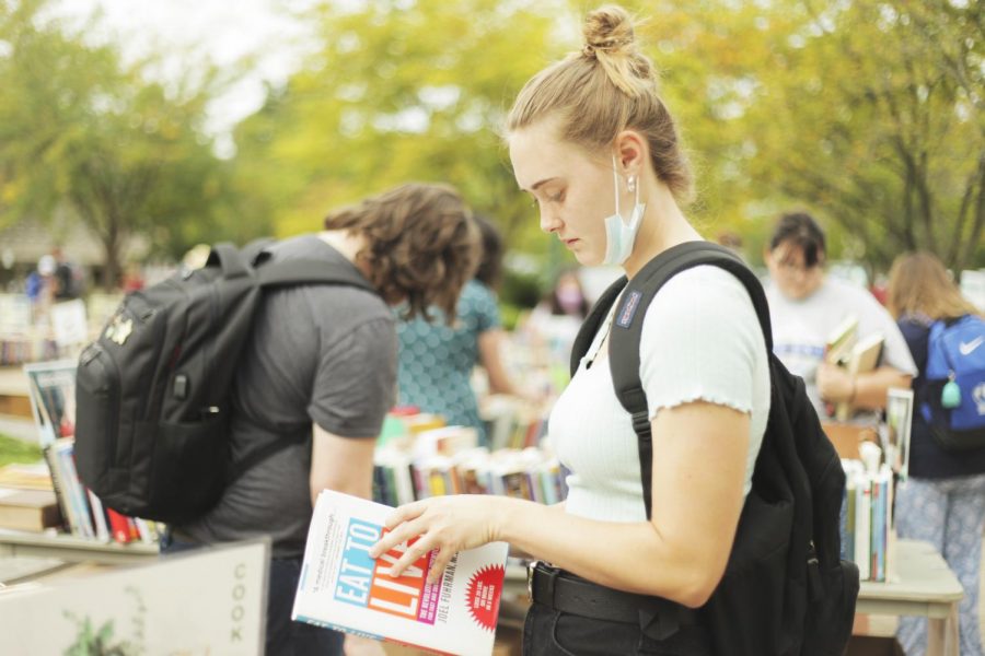 Lynsey Steffen, a senior biological sciences major, attends the Booth Library book sale that’s under the clock tower. 