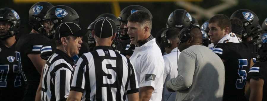 Eastern head coach Adam Cushing (center) talks with the officials during a timeout in the game against Illinois State on Sept. 18 at OBrien Field. Eastern lost the game 31-24 to the Redbirds in the 109th Mid-America Classic. 