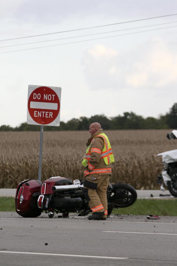 A member of the Charleston Fire Department investigates the motorcycle from the two-vehicle crash on Route 16 and Deerpass Road Monday evening. 