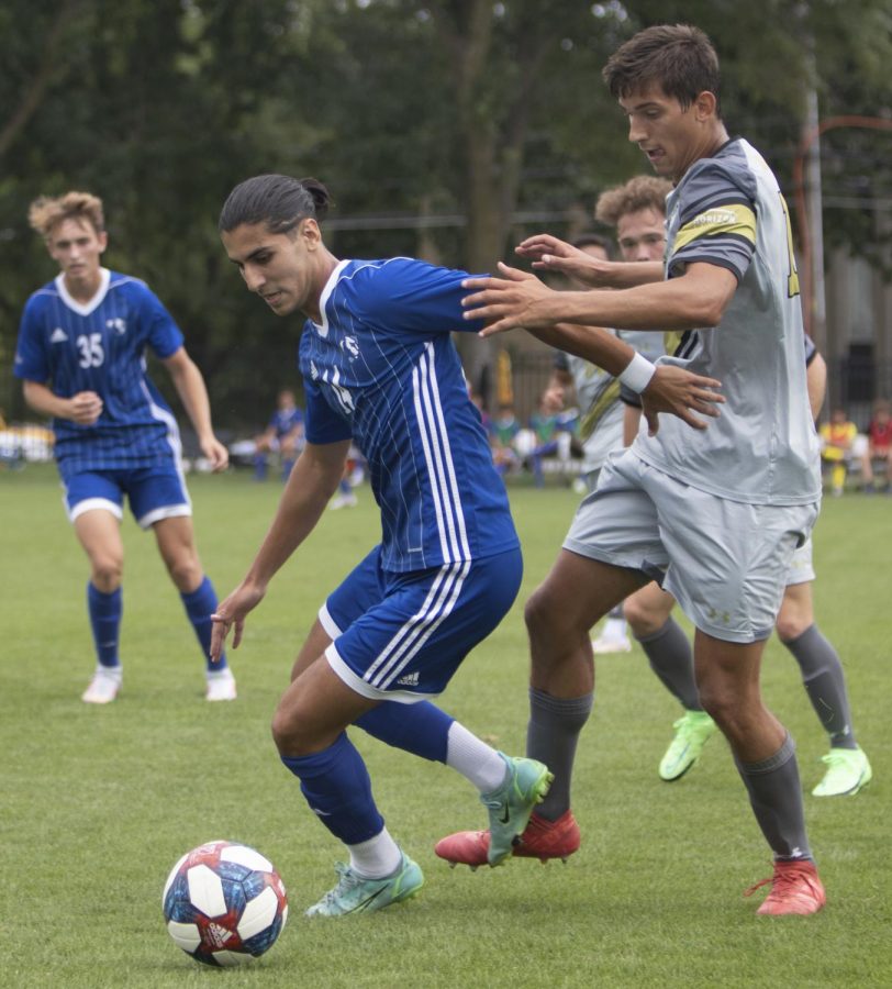 Eastern midfielder Munir Sherali keeps the ball away from an opponent in a match against Purdue Fort Wayne on Sept. 3 at Lakeside Field. Eastern lost the match 1-0. 
