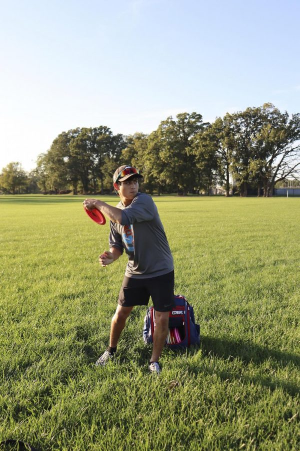 Tyler Warner, a freshman graphic design major, practices his craft, playing frisbee, during his free time and enjoys the nice weather outside.