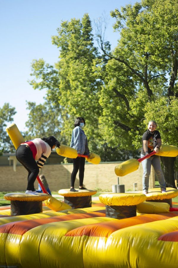 Amairany Bueno, a freshman management major, Evodie Tshipamba, an electrical engineering major, and Diana Maggi, a freshman biology major, compete against each other in inflatable jousting during the Kick-Off in the Library Quad.