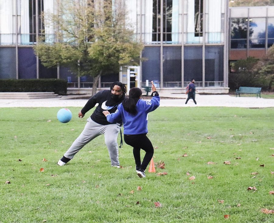 Alana Mcneely a junior human services major, runs to first base as Antwan Grahman a junior construction management major attempts to tag her out. 