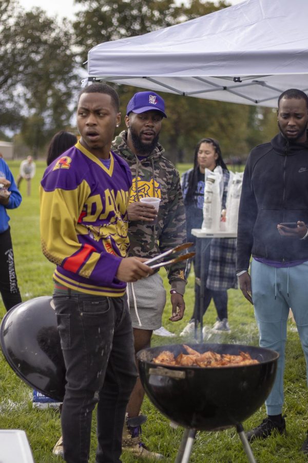 Anthony Lewis, a senior criminal justice major, grills buffalo chicken wings at the Saturday Homecoming Week tailgate outside of O’Brian Field. 