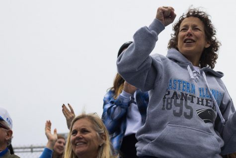 Christine Gristick, the mother of the linebacker’s coach, Adam Gristick, cheers for her son during the homecoming football game.