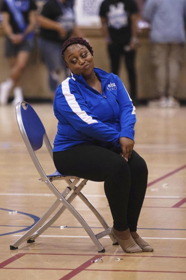 Cherish Crosby, a junior mass communication major, steals one of the chairs faster than her opponent in an intense game of musical chairs during the homecoming pep rally in McAfee gym Friday night.