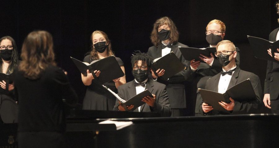 Member of the ensembles watch their director, Kellie Clark, give instruction for vocal cues. The concert took place Sunday afternoon and was called “Through Darkness to Light.” Clark said the selection of music was one of the hardest parts for this concert and that she wanted it to reflect the recent pandemic. 