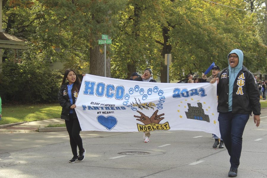 Members of Alpha Psi Lambda National Incorporated march in the homecoming parade.