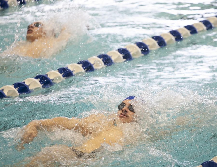 Eastern sophomore Jackson Penny competes in the backstroke segment of the 200 yard individual medley in a meet against Evansville on Oct. 9 at Padovan Pool. The mens swimming team lost the meet 125-76. 