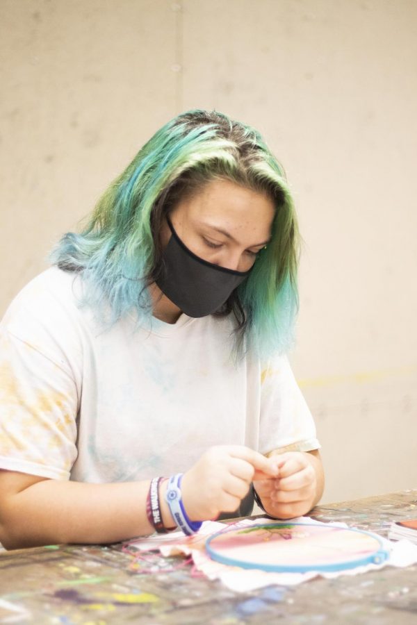 Diana Maggi, a freshman biological sciences major, creates a domestic life art project in Doudna Fine Arts Center. 