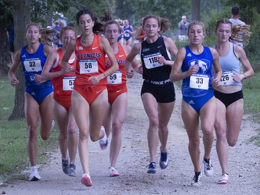 Eastern runners Lindsey Carlson (33) and Kate Bushue (32) compete in the EIU Walt Crawford Open on Sept. 3. 