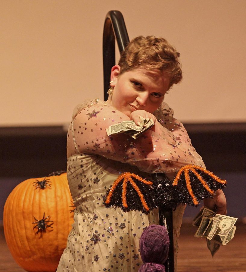 Roxy Flare poses with their tips collected from singing Mr. Brightside by The Killers at the Martin Luther King Jr. Grand Ballroom at the EIU Pride Drag Show Saturday night. Audience members could tip the performers in a variety of ways including bills, Venmo, Cashapp and PayPal. 