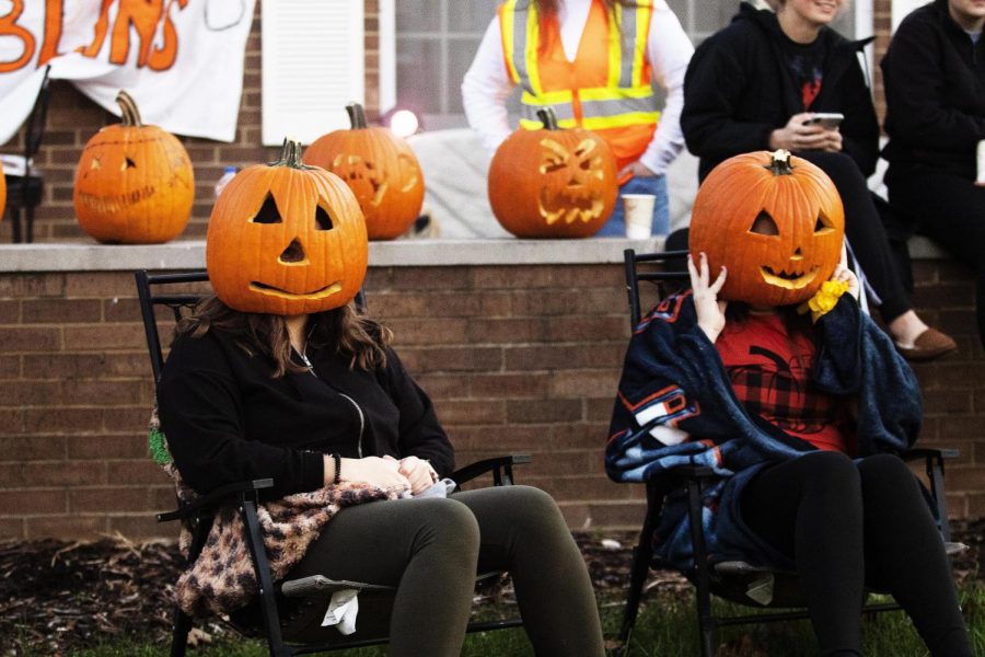 Rianna Rothermel, a sophomore early childhood education major, and Caleigh Miller, a junior sports management major, wear carved out pumpkins in the spirit of Halloween during the Greeks and Treats event Sunday night. 