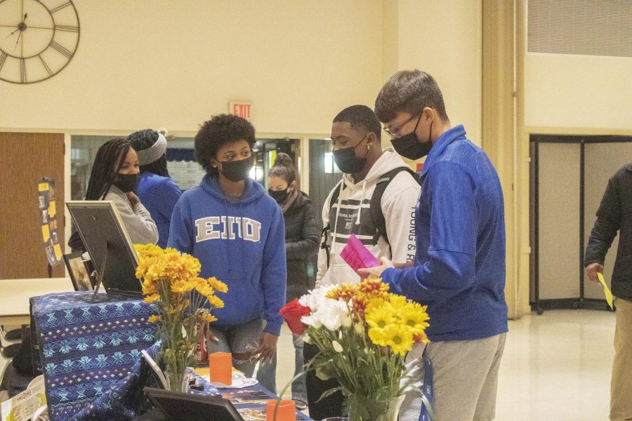 Alicia, a sophomore biological sciences major, Jaheel Perrin, a sophomore sport management major, and Riley Baker, a senior physical education major, admire Jason Aguilar’s ofrenda during the Dia de los Muertos ofrenda exhibit where they honor those who have passed, inside the University Ballroom of the Martin Luther King Jr. University Union.