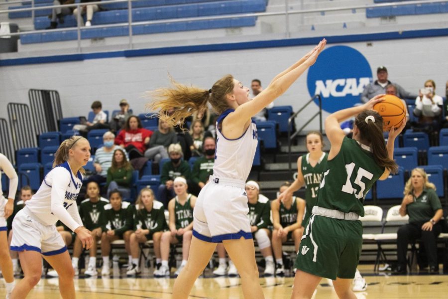 Kira Arthofer, a senior guard, attempts to block a shot from an Illinois Wesleyan player at the Wednesday night women’s basketball game in Lantz Arena. Arthofer scored a total of 16 points. The Panthers won 83-54 against the Titans.