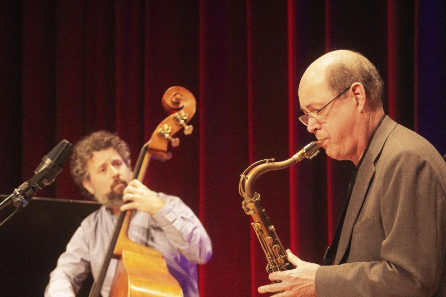 Sam Fagaly plays the saxophone as bassist Andrey Gonçalves looks toward him during Sunday evening’s Jazz Faculty Concert in Dvorak Doudna Fine Arts Center.