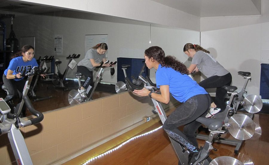 Anahi Osorio, a sophomore excercise science major, teachers her cycling class with her student Sarah Carr, a junior special education major at The Student Recreation Center Saturday. 