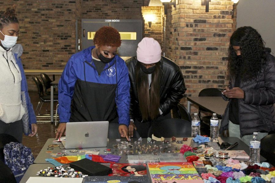 Shavon Edmond, a sophomore sociology major, helps out a customer at the Back to Business: Small Business Expo Saturday afternoon at 7th Street Underground. Edmond started her business earlier in the summer. Edmond said she just started meddling with things and just got interested in seeing inspiration on apps like Tik Tok. “I started to just make it on my own, and like just branched off from there.” 