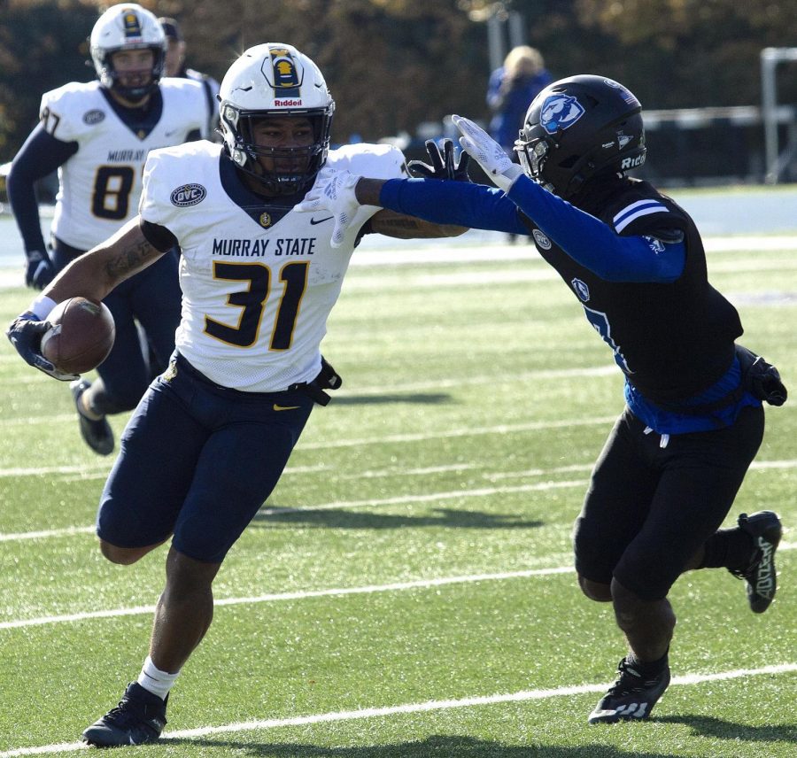 Murray State freshman running back Damonta Witherspoon stiff arms Eastern freshman defensive back Tyris Harvey. Witherspoon would go on to rush for 135 yards on 16 carries, including a touchdown, to propel the Racers to a 20-13 victory on Saturday at O’Brien Field. 