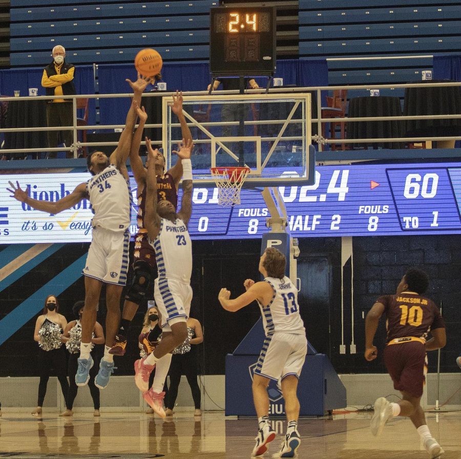 Eastern forward Jermaine Hamlin (34) jumps to deflect an inbounds pass in the final seconds of Easterns loss to Central Michigan on Nov. 15. The pass was gathered by Central Michigan guard Jermaine Jackson Jr. (10) who scored on a layup as time expired, giving the Panthers a 62-61 loss. 
