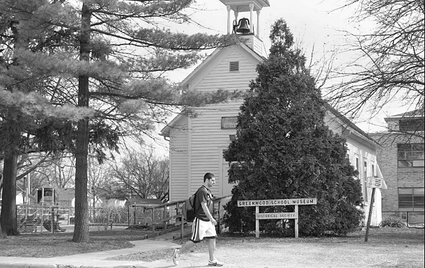 Joey Veronico, a junior marketing major from Hoffman Estates, walks past the Greenwood School Museum on March 31, 2010.