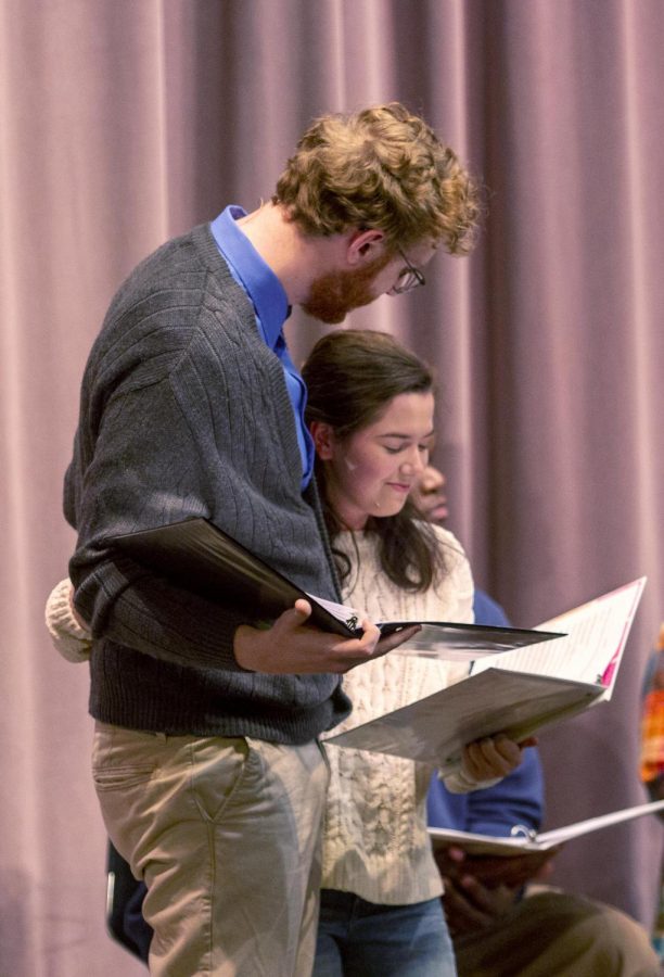 Max Zumpano, a senior theater major, and Marie Mullinax, a freshman theater major hug during the “Love, Garland, Bows, and Tinsel: A Holiday Radio Romance” Friday. The play was student produced and aired on the radio.