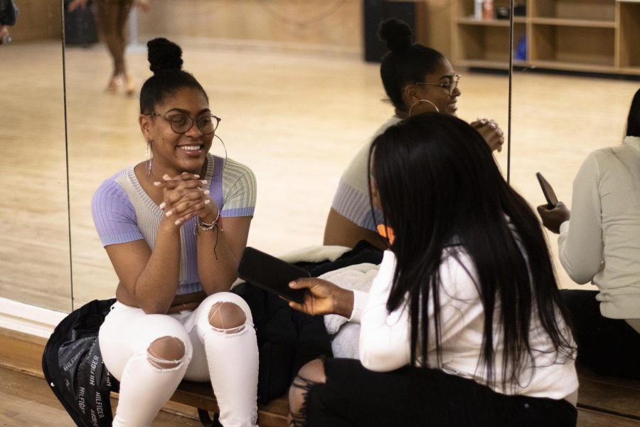 At the auditions for Eastern couture models hosted by Femi Usikalu, a senior digital media major, in McAfee Gym Thursday night, Starr Smith, a junior community health major, and Celeste Ditu, a senior interpersonal communications major, chat with each other before the auditions start. 