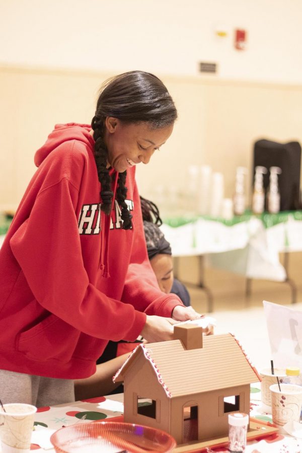 Julianna Holloway, a sophomore biology major, helps her team, “The Powerpuff Girls,” in decorating their gingerbread house for the Gingerbread Head-to-Head contest in the University Ballroom in the Martin Luther King Jr. University Union.