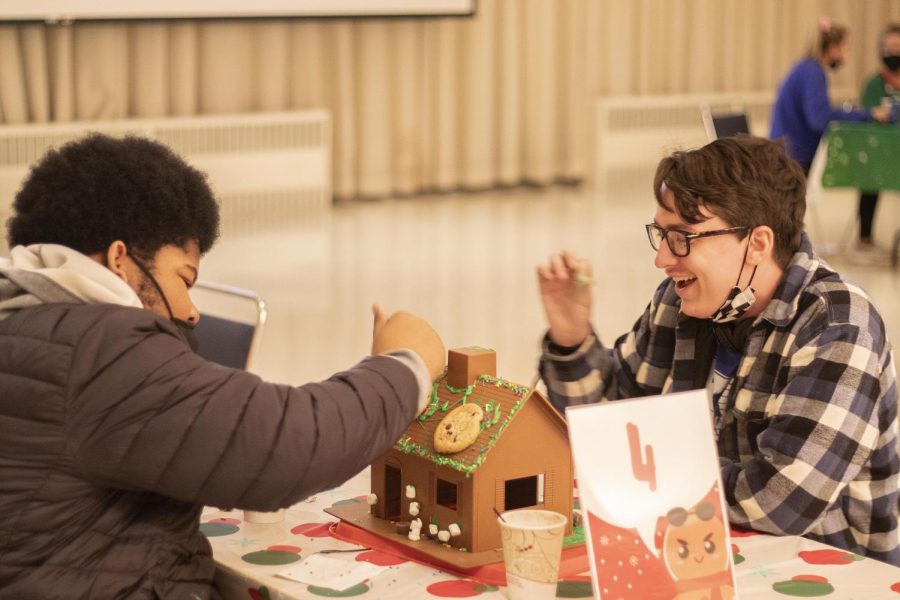 Omar Ikramer, a freshman history major, and Ryan Beavers, a freshman film production major, compete against other teams in the Gingerbread Head-to-Head contest in the University Ballroom in the Martin Luther King Jr. University Union. 