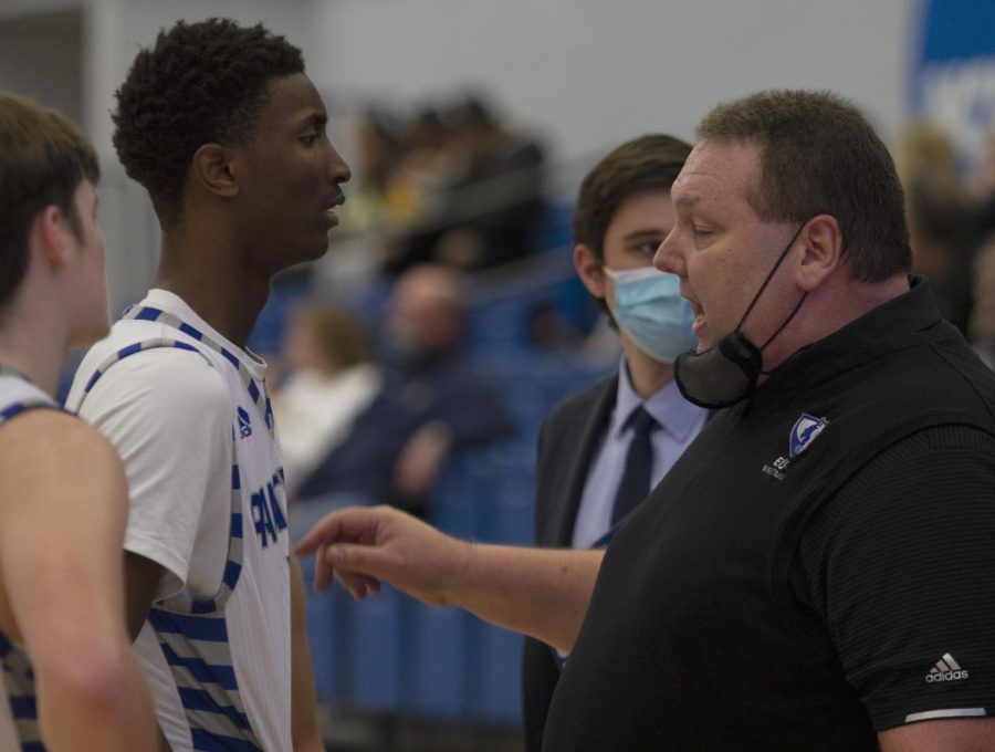 Eastern head coach Marty Simmons talks to freshman forward Paul Bizimana during a timeout in the Panthers game against Murray State on Jan. 17 in Lantz Arena. Eastern lost the game 72-46.