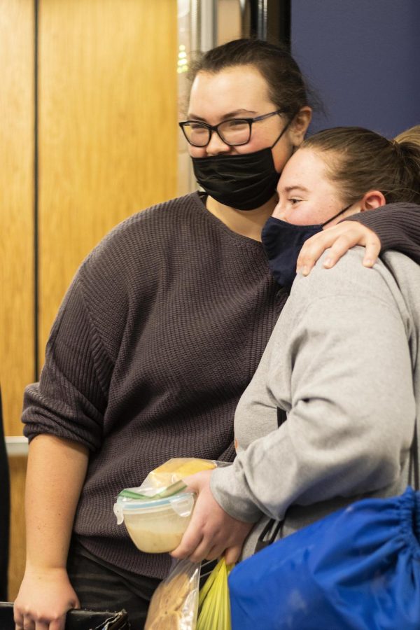 Elizabeth Wilder, a freshman undecided major, hugs her friend, Rileigh Haarmann, a freshman communication disorders and sciences major, when she gets off the elevator while moving back into the residence halls for Spring semester. 