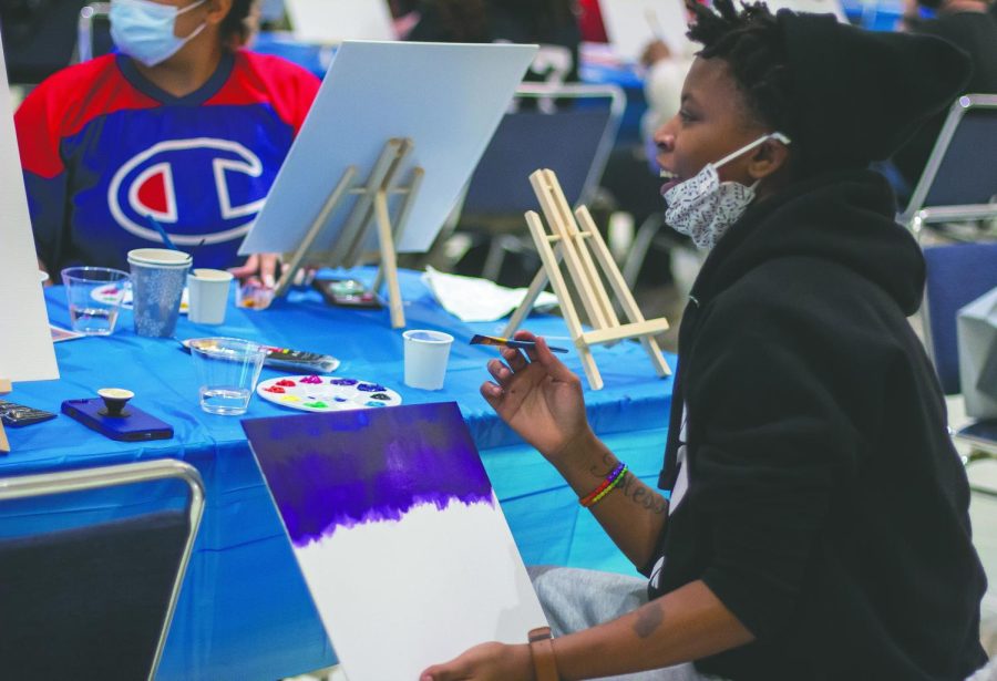 Maylia Wesley, a freshman engineering technology major paints at the UB Express Yourself! Paint-N-Sip mixer, for part of the Winter Welcome Days, at the University Ballroom in the Martin Luther King Jr. Union Monday, Jan. 10, 2022. 