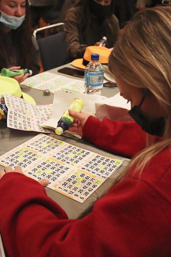 Katelind Winterland, a freshman business major, focuses on her bingo cards while with a group of friends in the Grand Ballroom for the Winter Welcome Dayz event on Tuesday night.