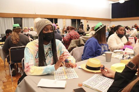 Kennedi Johnson, a freshman psychology major, socializes with her new friend that she met while playing bingo in the Grand Ballroom Tuesday night.