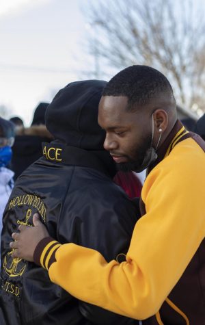 Kyreon Williams, a senior interdisciplinary health science major at the University of Illinois at Urbana-Champaign, hugs a fellow member of Iota Phi Theta Fraternity Incorporated during the balloon release in honor of Kristian Philpotts Saturday afternoon.