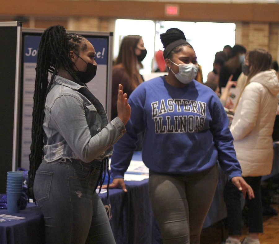 University Board members Destiny Dye, the human potential coordinator, a senior early childhood education major, and Hannah Lawrence, the spotlight coordinator, a freshman pre-nursing major, advertise and promote University Board at Pantherpalooza on Tuesday.