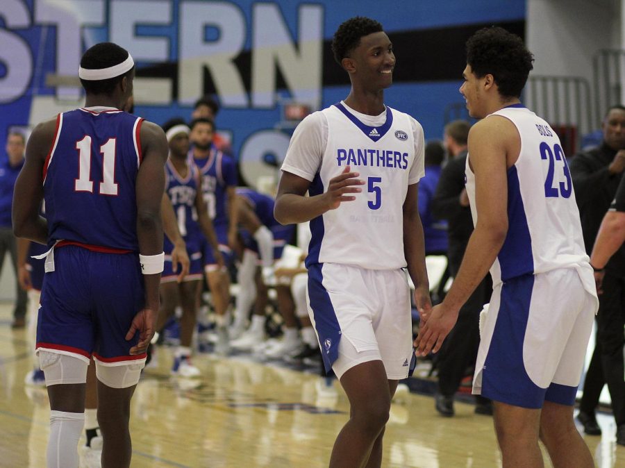 From left, Paul Bizimana, a freshman forward, and Rodolfo Bolis, a freshman forward,  celebrate winning the men’s basketball game on Saturday against Tennessee State Tigers at Lantz Arena. Bizimana had 20 points and 11 rebounds. The Panthers won 78-70 against the Tigers.