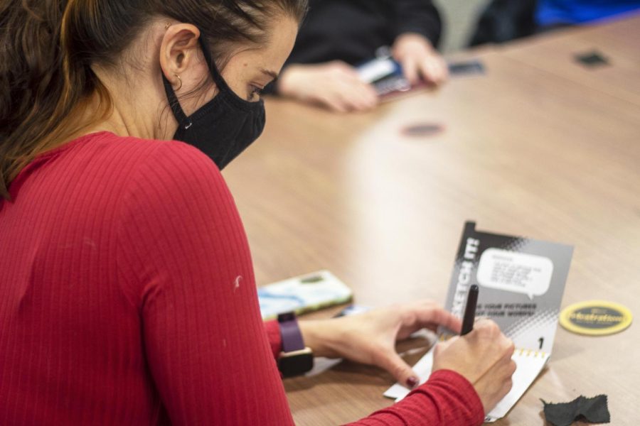 Graduate Supervisor for Freshman Connection, Jess Meadows, a graduate student studying counseling, plays a drawing game with freshman at the Freshmen Connection game night at Lawson Hall Wednesday, Jan. 19, 2022. 