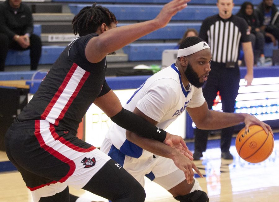 Eastern forward Sammy Friday IV drives toward the basket in the mens basketball game against Austin Peay on Saturday in Lantz Arena. Friday led the team with 13 points in the game, which Eastern lost 64-52. 