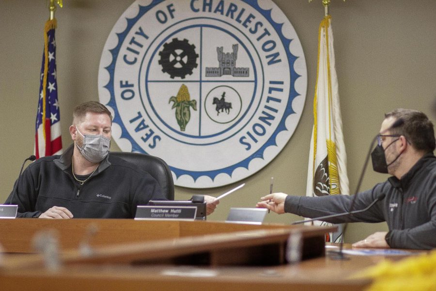 Charleston Mayor, Brandon Combs passesa bill to for City Council Member Dennis Malak to sign stating the approval of a resolution at Tuesday, Feb. 1, 2022’s City Council meeting at City Hall.