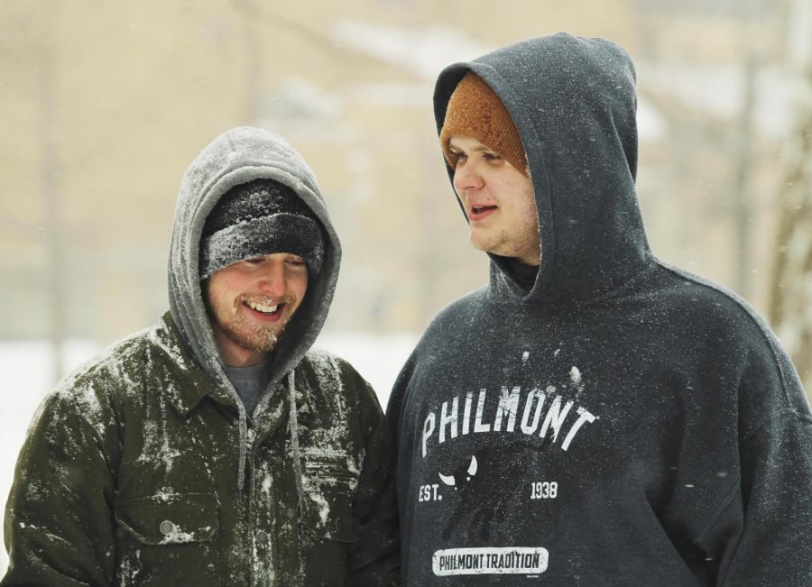 Seth Durbin, a senior middle level education major, and Harrison Walker, a senior computer information technology major, both spend the day having fun in the snow and throwing snowballs at each other in the library quad.