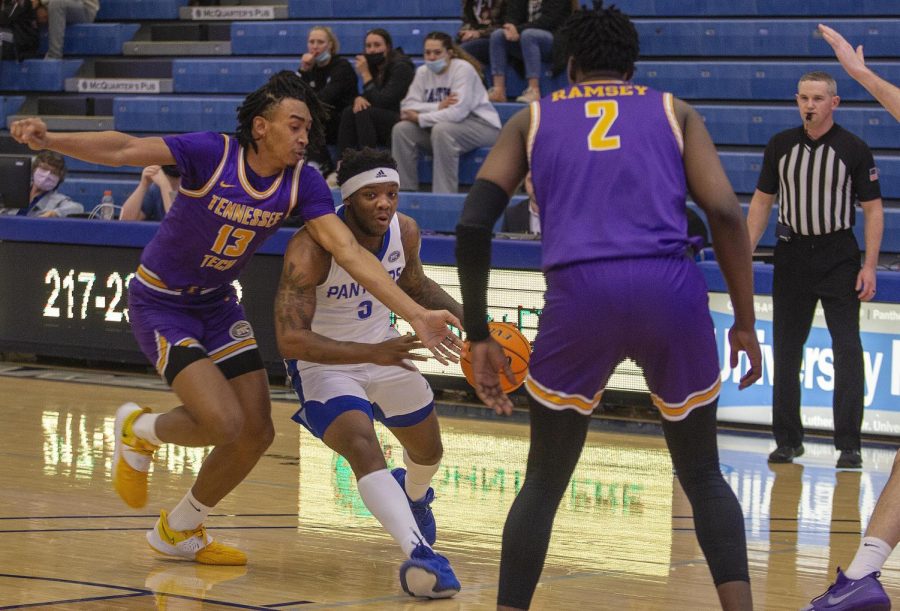 Guard Kejuan Clements, a junior interdisciplinary studies major, rushes the ball past the 3-point line at the Thursday men’s basketball game against Tennessee Tech at Lantz Arena. Clements had seven points. The Panthers lost 73-62 to the Golden Eagles.