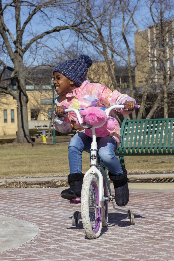 Kylee W. rides her bike while walking with her mom, Shaunice L.  on Sunday.