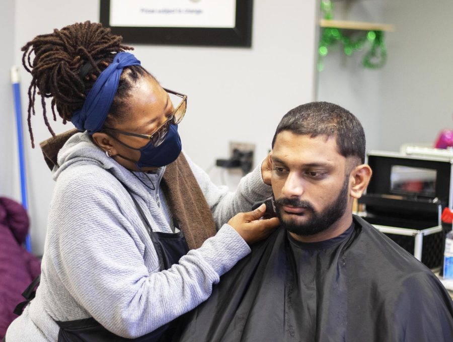 Jewel Harbin takes care of a customer, Shantan Mukesh, a computer science graduate student. The old hair salon reopens with an open house event on Tuesday afternoon by Jewel Harbin, the owner of HHD Salon which is located in the lower level of Martin Luther King Jr. University Union. Harbin says she feels blessed because of the reopening and mentions, [Im] happy to be here, Eastern has a great group of people and to be offering a service to Charleston is the main thing.