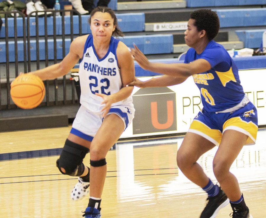 Junior guard Lariah Washington drives toward the basket while Jazmyn Gaines-Burns, a freshman guard for the Morehead State Eagles, tries to guard Washington. The Panthers won 68-56 against the Eagles Thursday night at Lantz Arena. Washington scored 22 points in the game. 