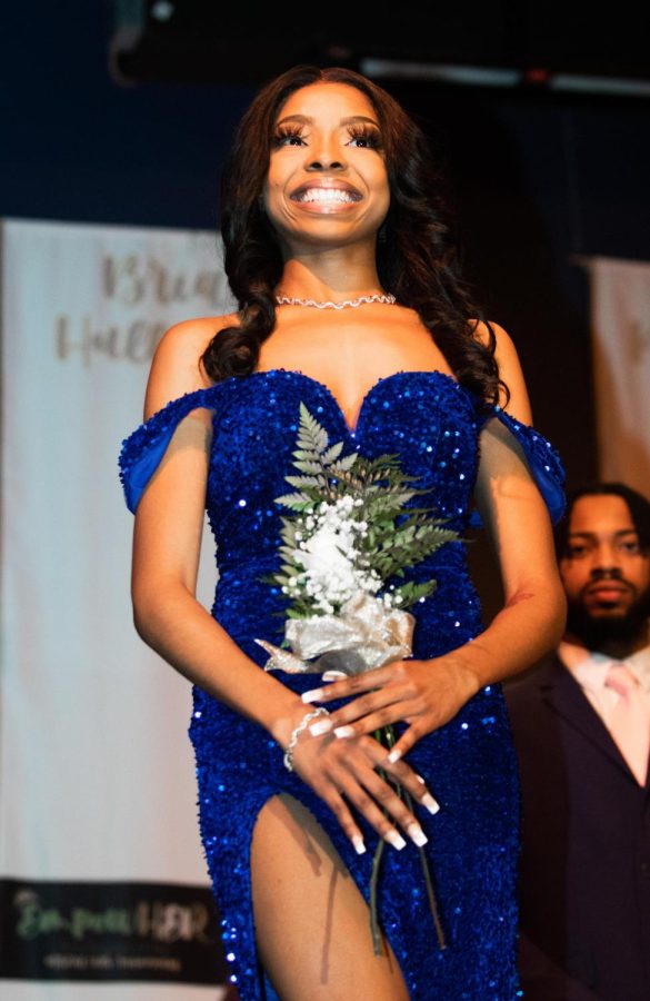 Brianna Hall-Dennis, a junior political science major, smiles at the audience after answering her impromptu question at the 50th Anniversary of Miss Black EIU on Saturday night.