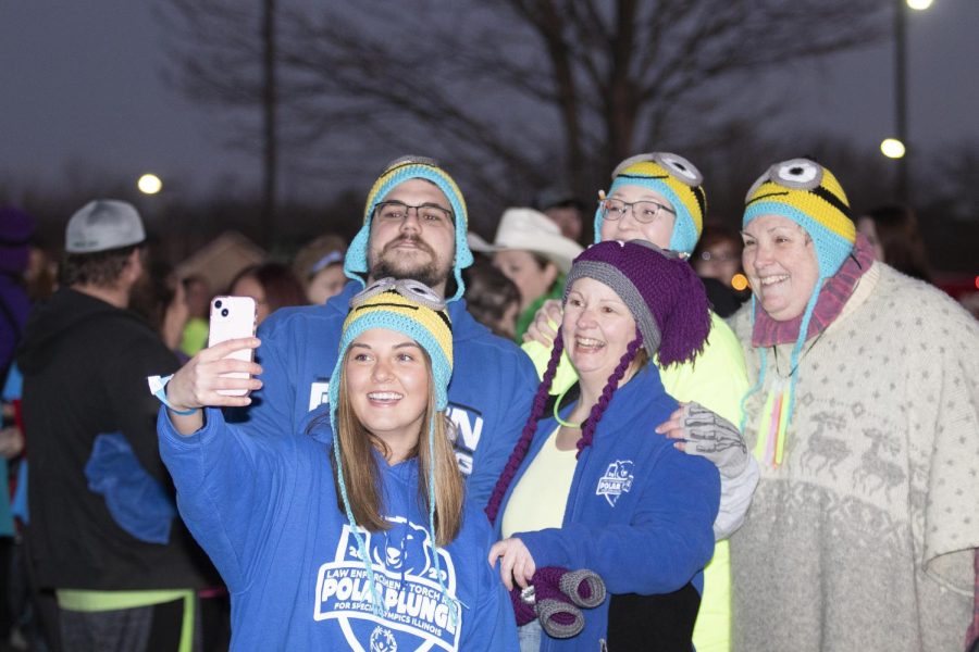 A family takes a selfie together before the polar plunge starts. Eastern Illinois University students and faculty along with Charleston, Ill. community members compete in the 2022 Law Enforcement Torch Run Polar Plunge for the Special Olympics Illinois on Sunday.