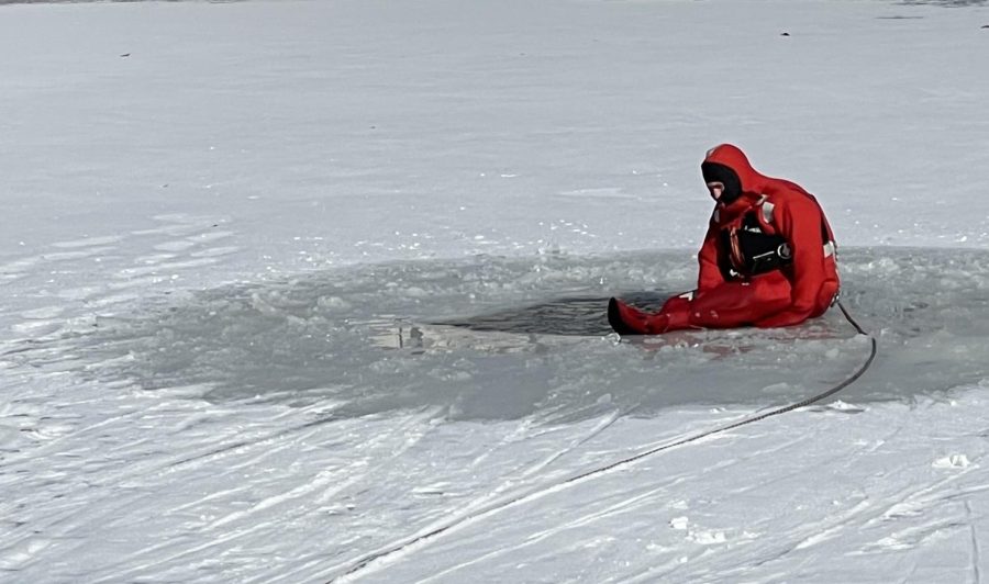 Jeff Adkins, a member of the Charleston Fire Department, sits on the edge of a hole in the frozen pond behind 9th Street Hall Tuesday morning. Adkins acted as an individual needing to be rescued to allow the department to practice water recuses in icy conditions.