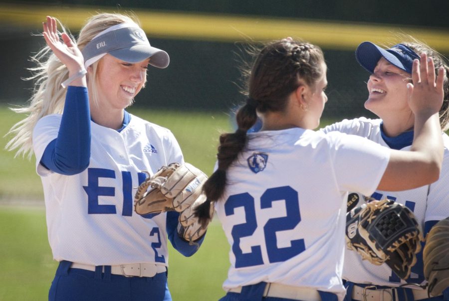 Eastern softball players (from left) Megan Burton, Alexa Rehmeier and Hannah Cravens celebrate after winning game one of a double header against Morehead State on Sunday at Williams Field. Rehmeier threw a one-hit shutout in the game and Burton and Cravens each scored a run in the 4-0 victory. 