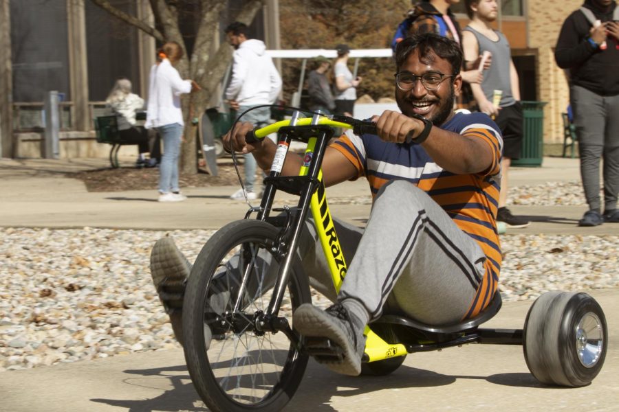 A student has fun racing go-karts around the Library Quad at the pop-up mental health day event sponsored by Student Affairs on Wednesday afternoon. Fun activities to participate in included petting comfort dogs, playing a game of spike ball or cornhole, catching footballs, playing soccer, and eating ice cream sandwiches or Italian Ices.